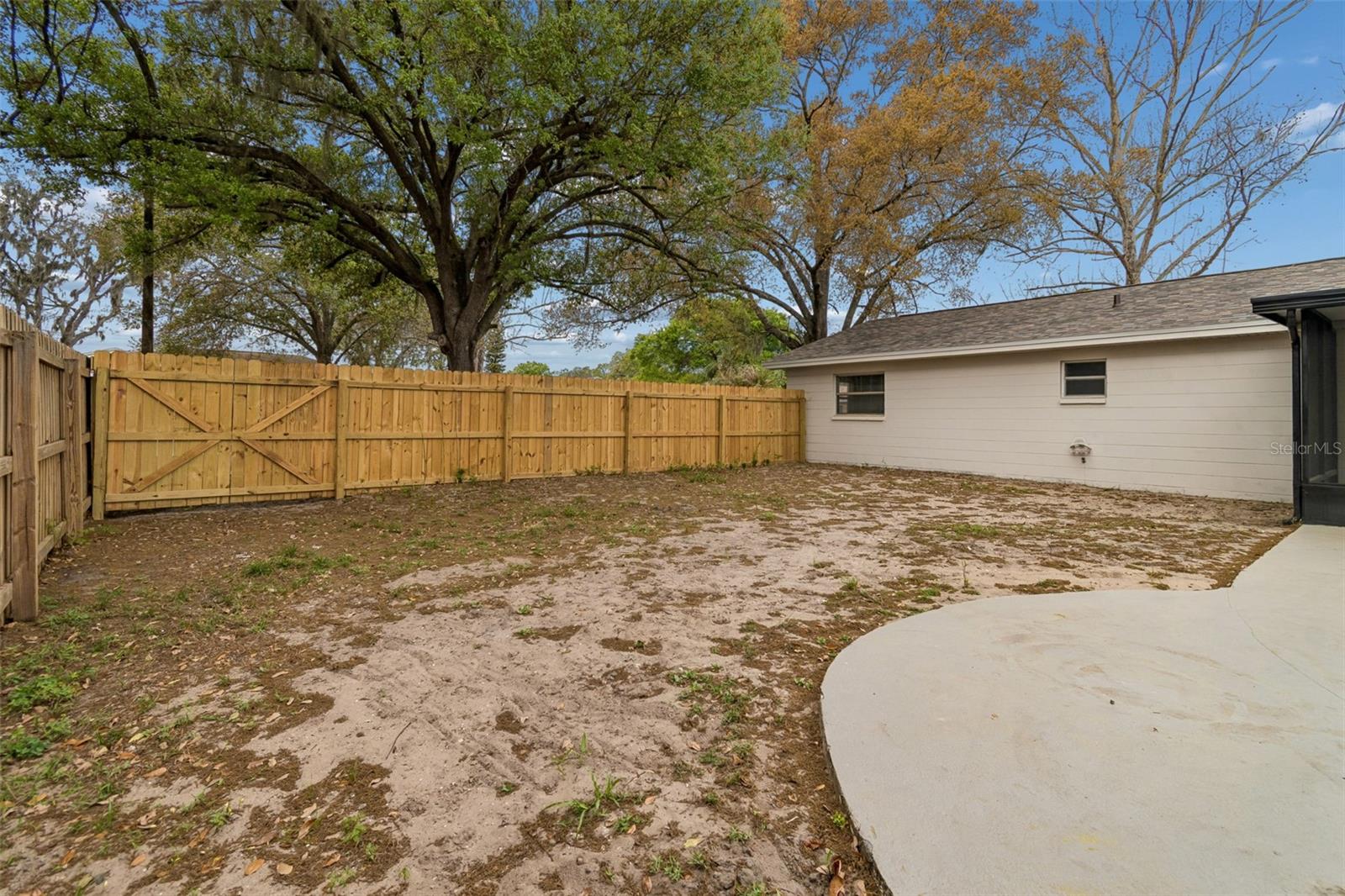 Backyard with pool and screened patio offering plenty of space for someone ready to roll up their sleeves and create their own outdoor retreat. The yard is currently ready for landscaping and would be a great project for a buyer who enjoys gardening or designing their own outdoor space.