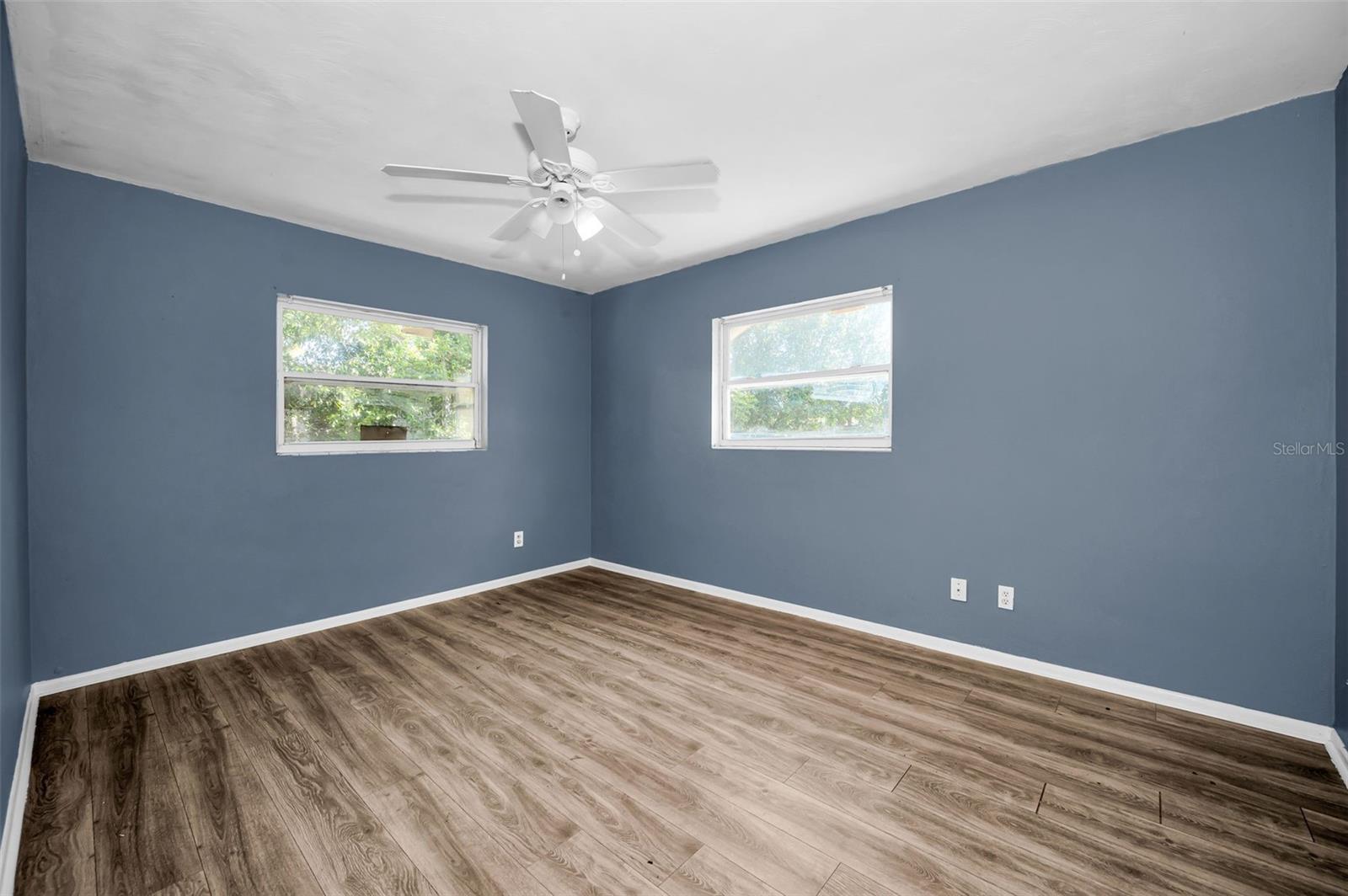 Bedroom with 2 windows & fan