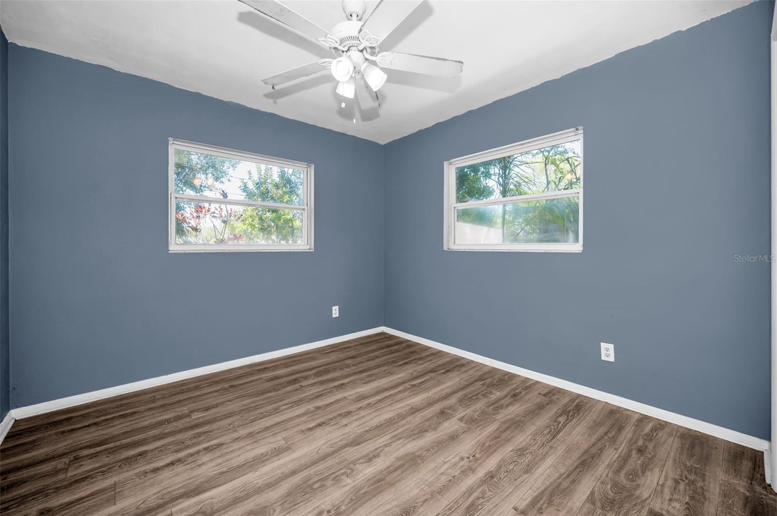 Bedroom with 2 windows & fan