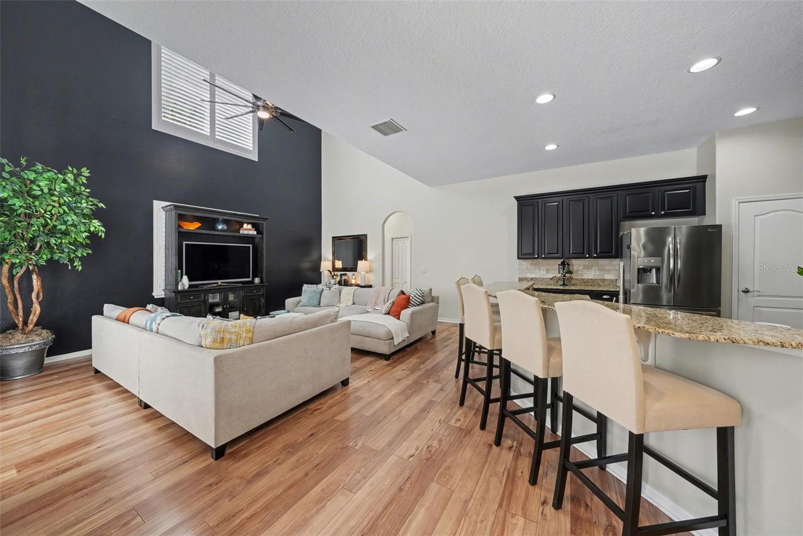 Your family room and kitchen at the rear of the home with access to pool.