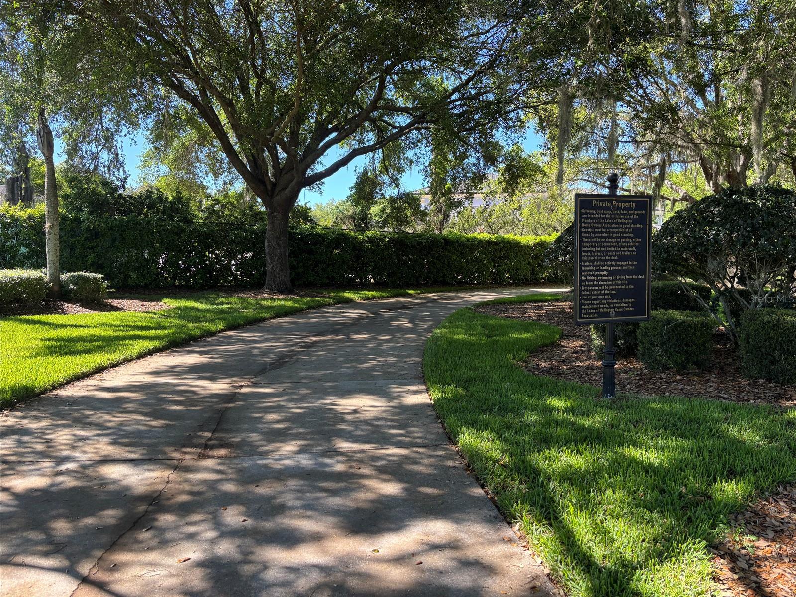 Private drive leading to neighborhood boat ramp and dock.