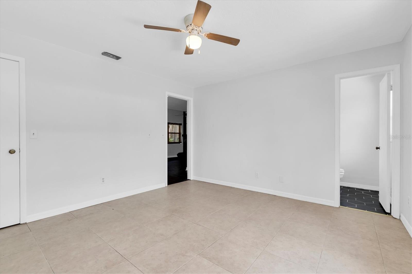 View of closet and into bathroom