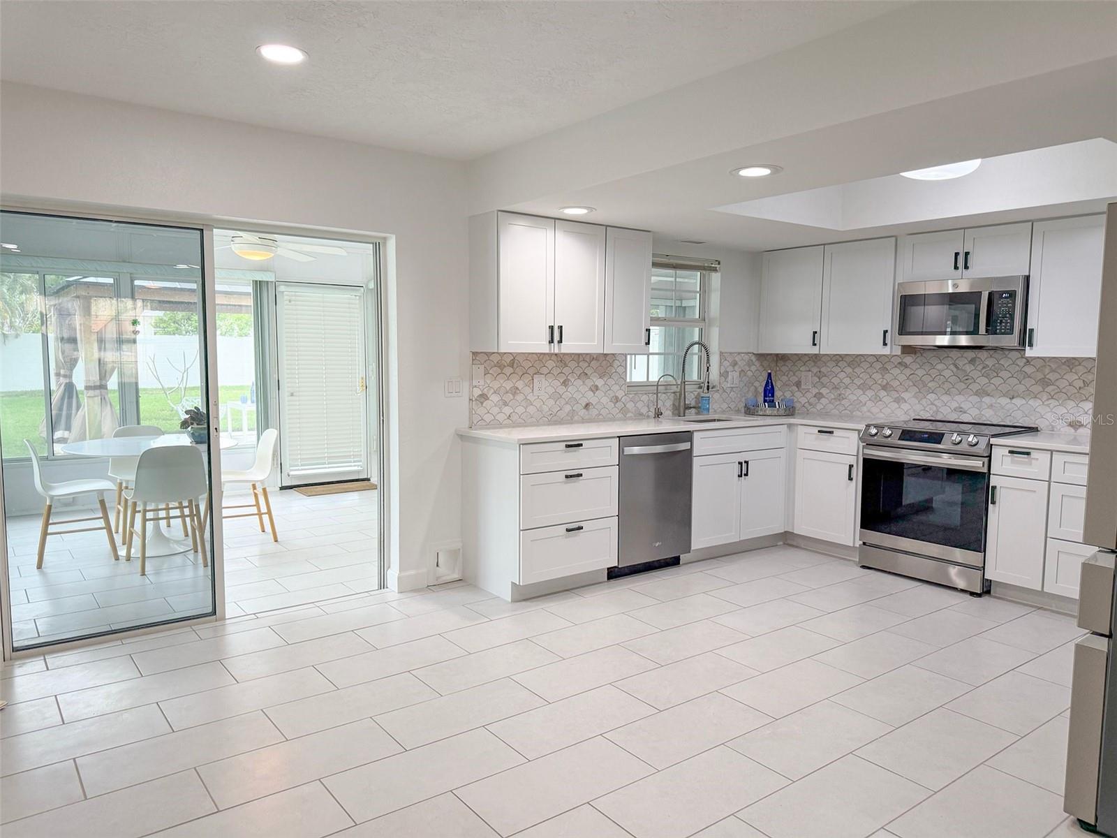 Kitchen. Sliders to sun room