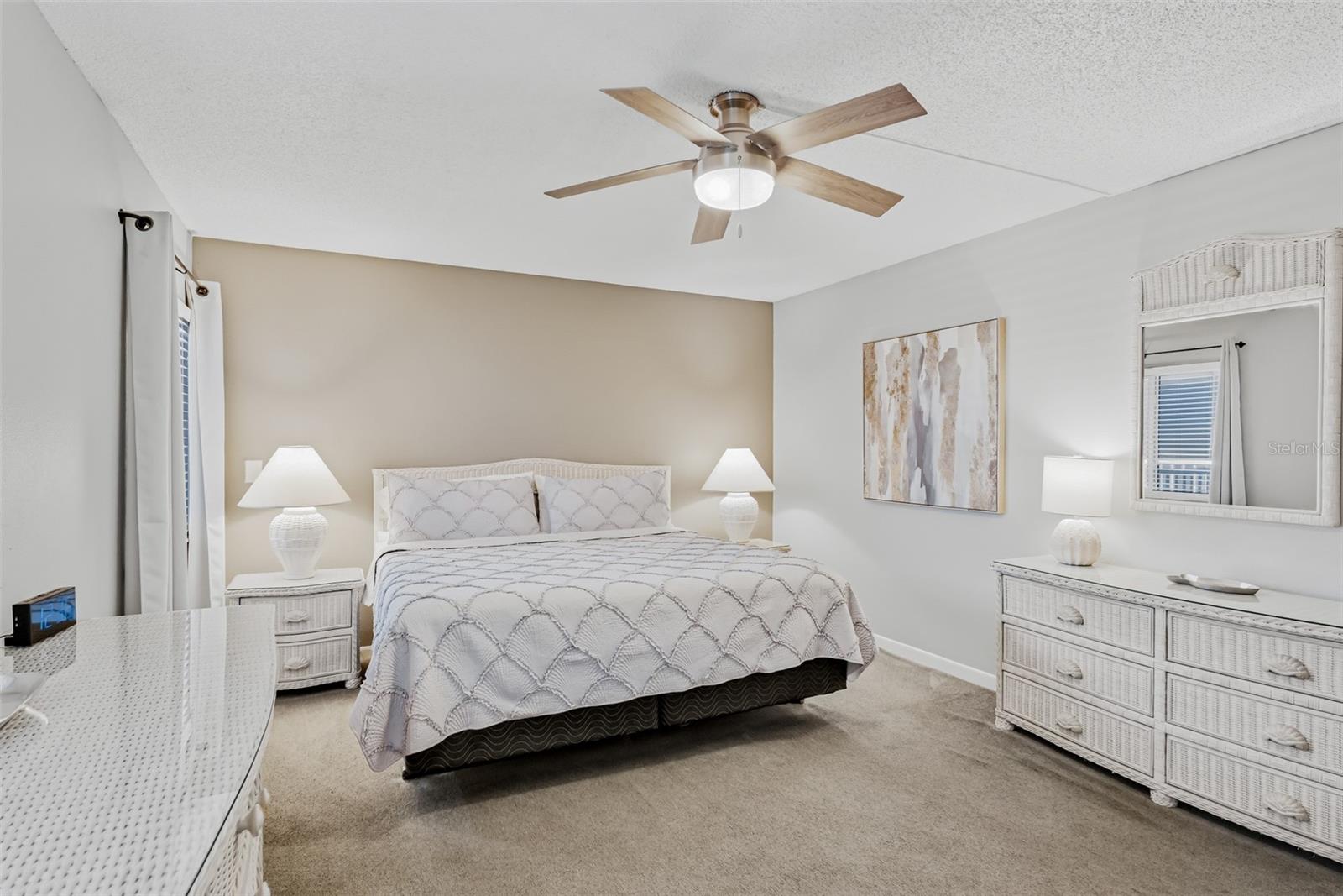 Spacious primary bedroom with a king bed