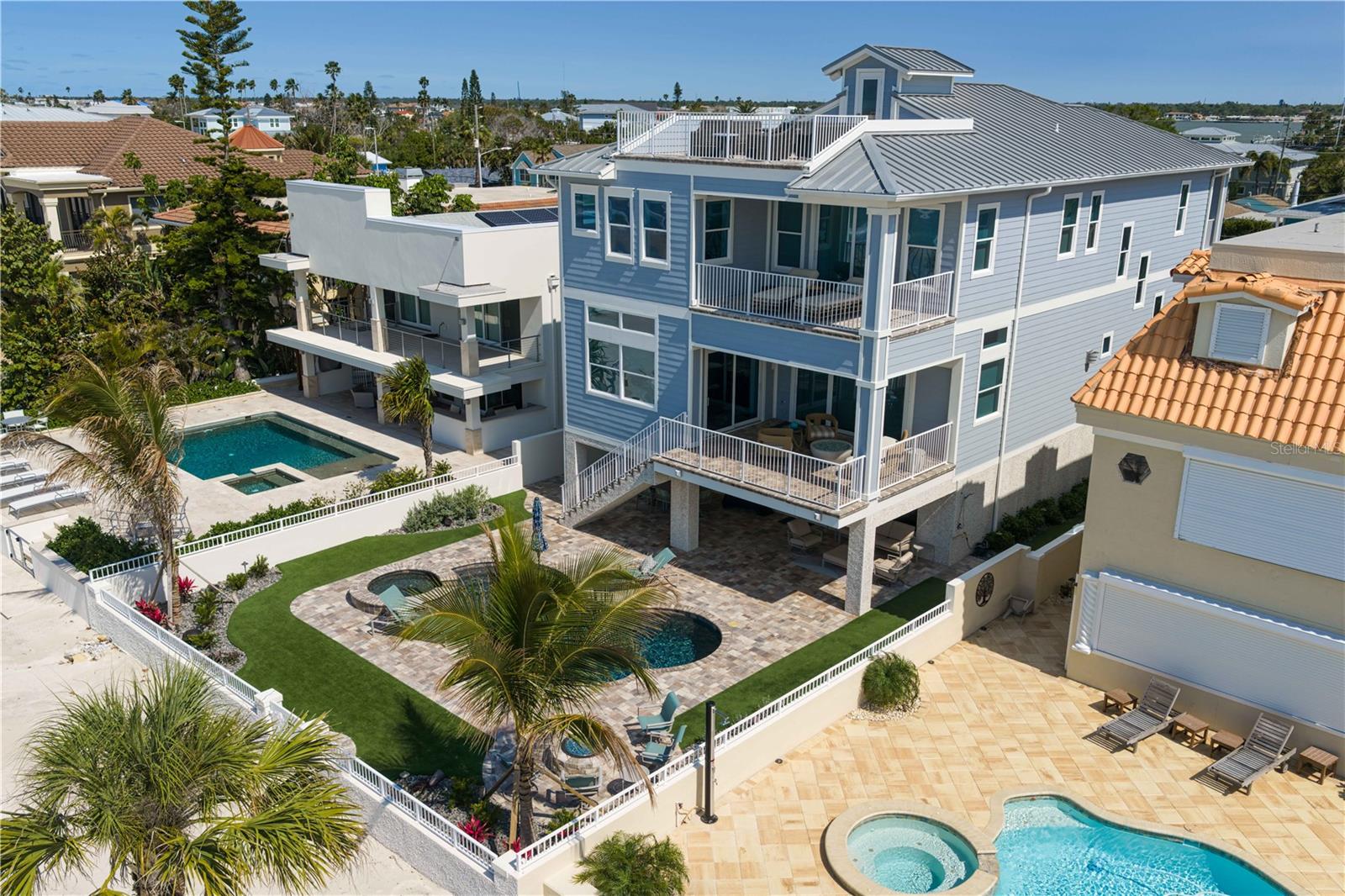 The home sits tall with high ceilings on each living level; notice the roof top terrace with views that extend to the Don Cesar Hotel and Egmont Key.
