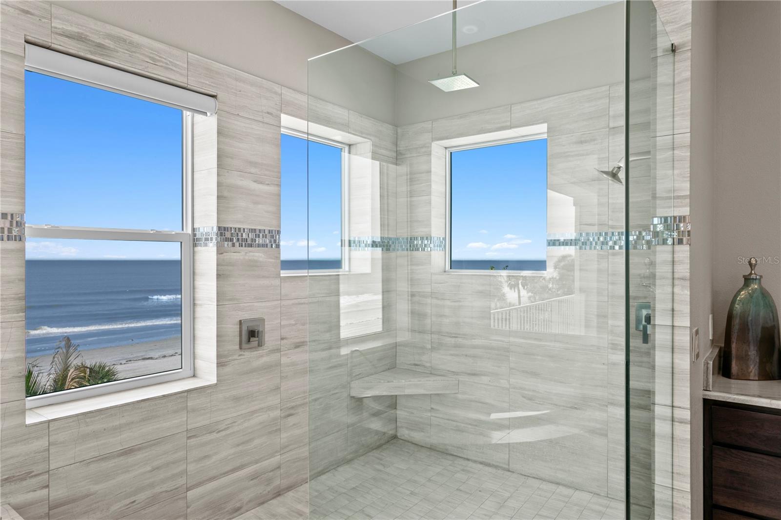 The oversized walk in shower with 3 windows 2 shower heads and jets