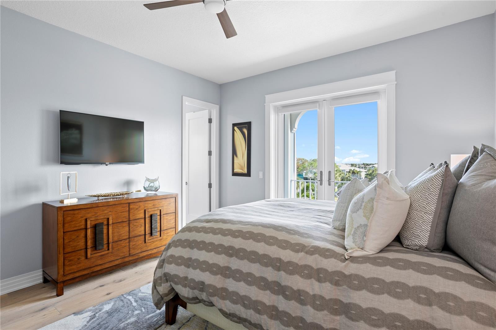 Guest Suite 2 enjoys loads of natural light with a private balcony, an en suite bath and walk in closet