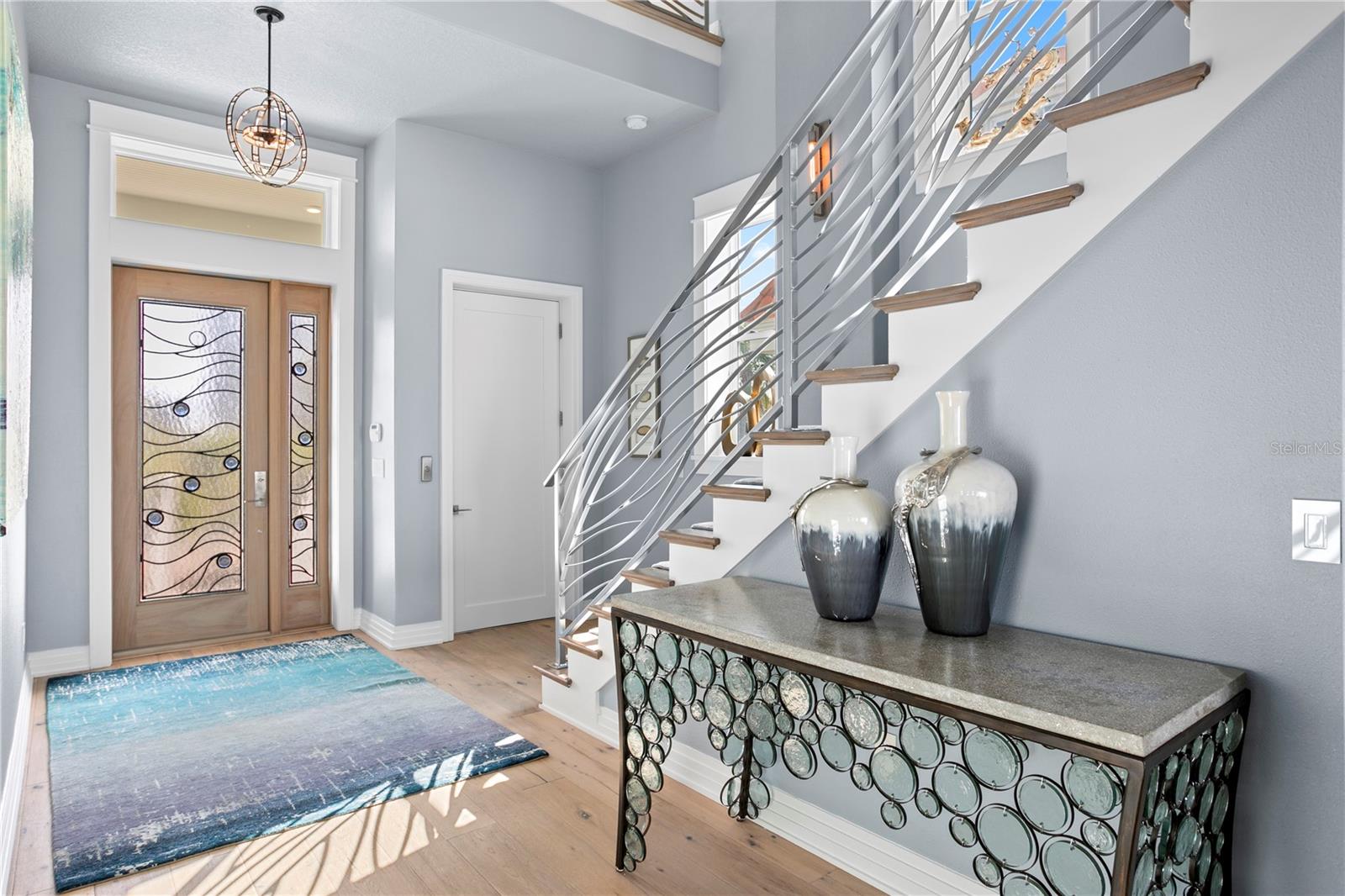 The substantial entry door greets you and guests alike, and was owner curated to continue the softness of lapping waves from the Gulf.