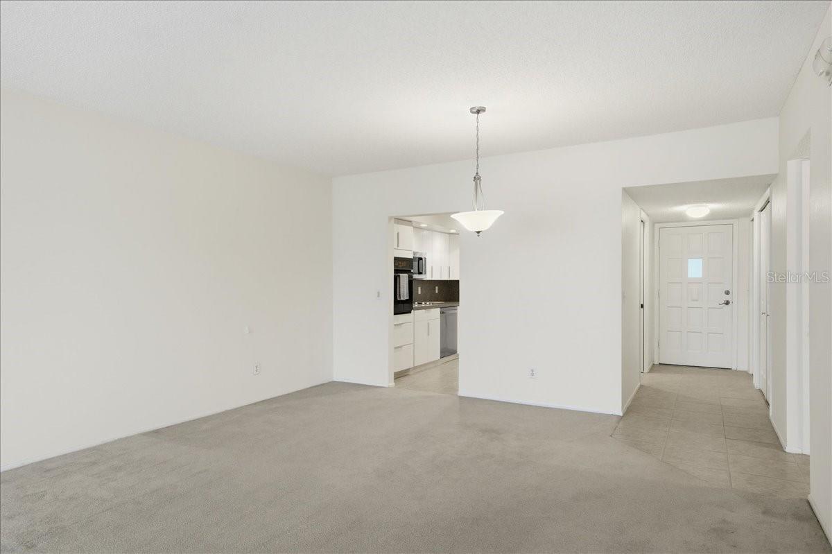 Dining area toward kitchen and front door