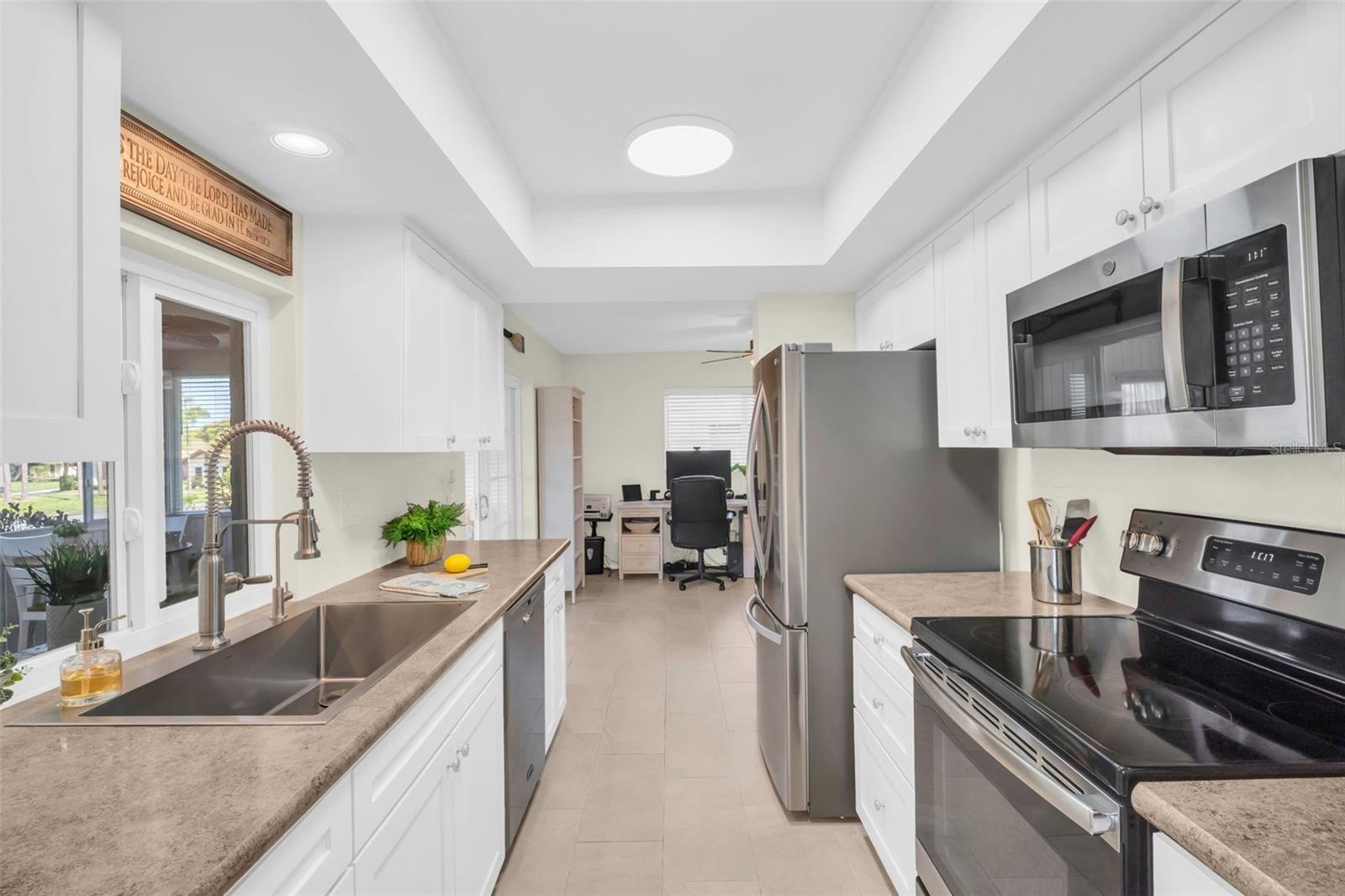 Updated with wood cabinetry, raised tray ceiling, and newer fixtures~