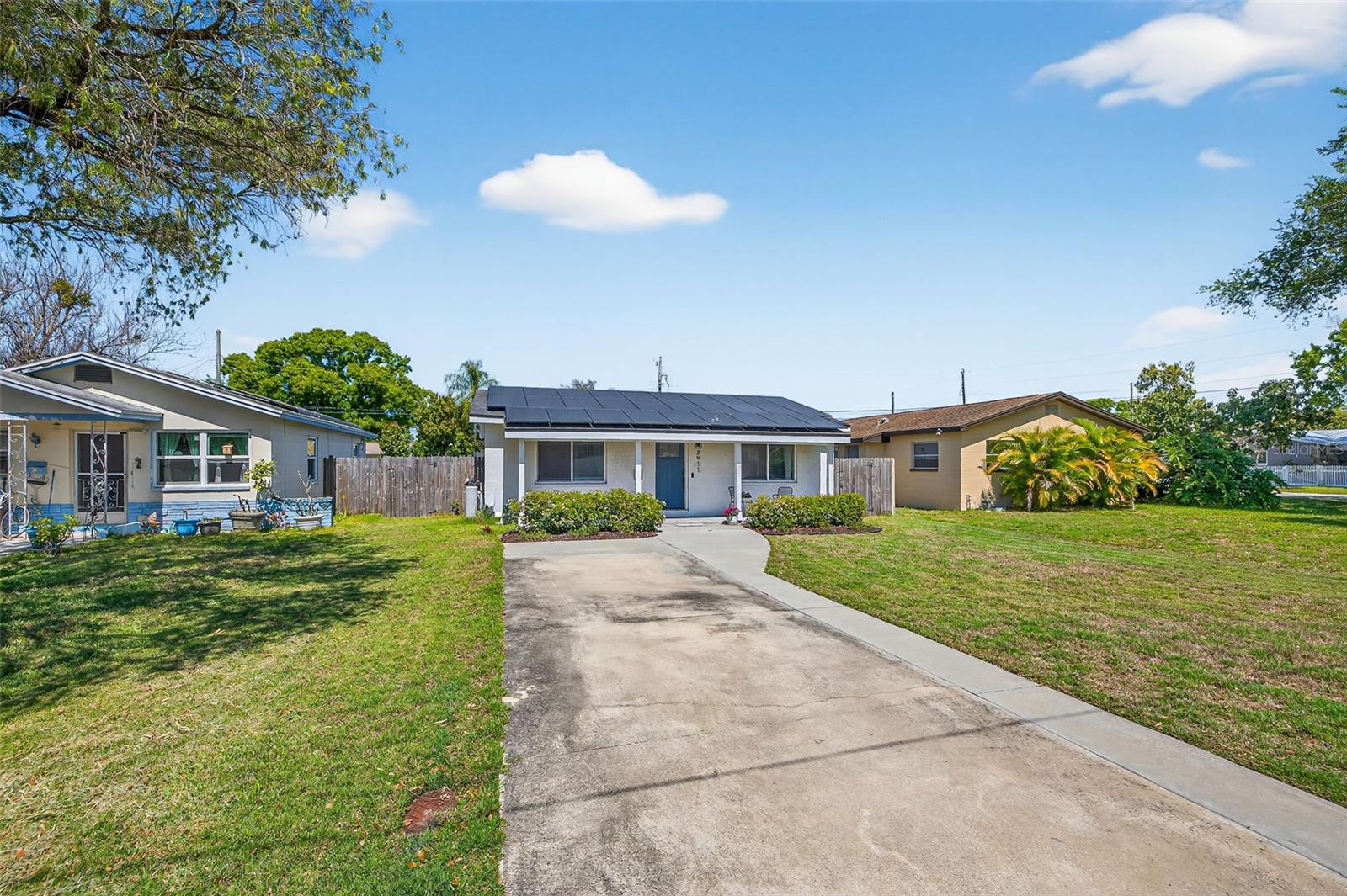 A spacious front yard with driveway and alley parking in back.