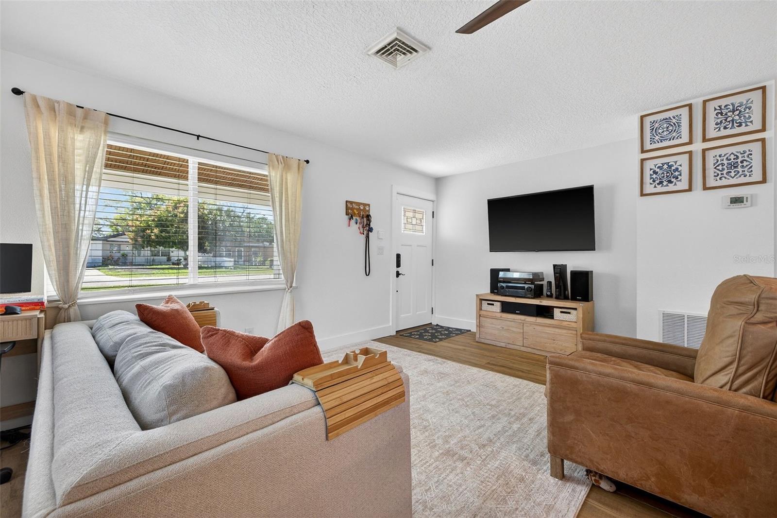 Cozy living area with large hurricane-impact windows.