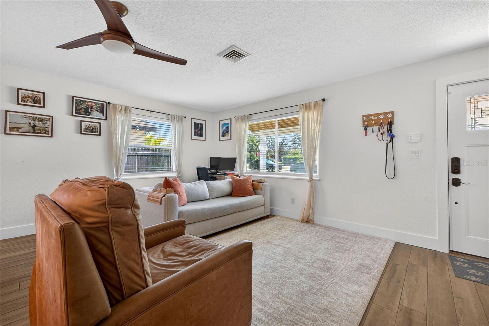 Inviting living space featuring expansive windows and modern finishes.