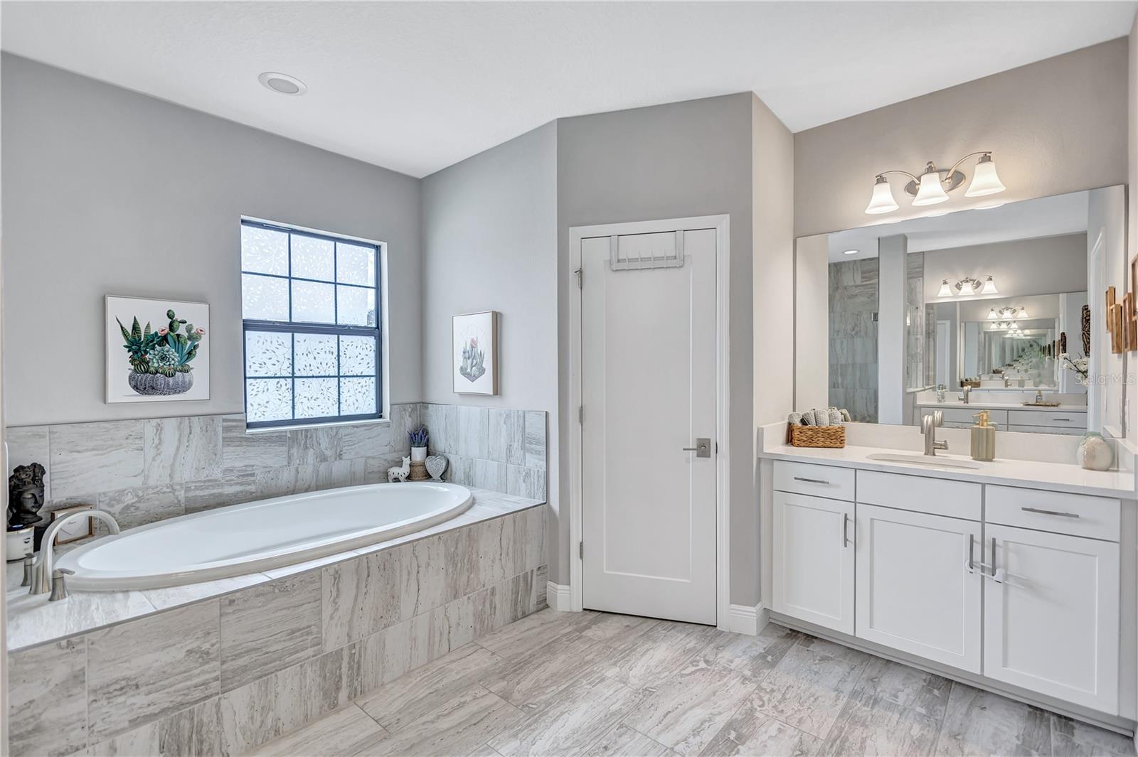 Dual vanities provide plenty of space, while separate water closet adds an extra layer of privacy.