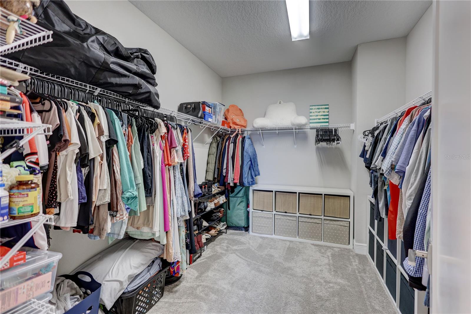 Expansive walk-in closet offering generous space for wardrobe & storage!