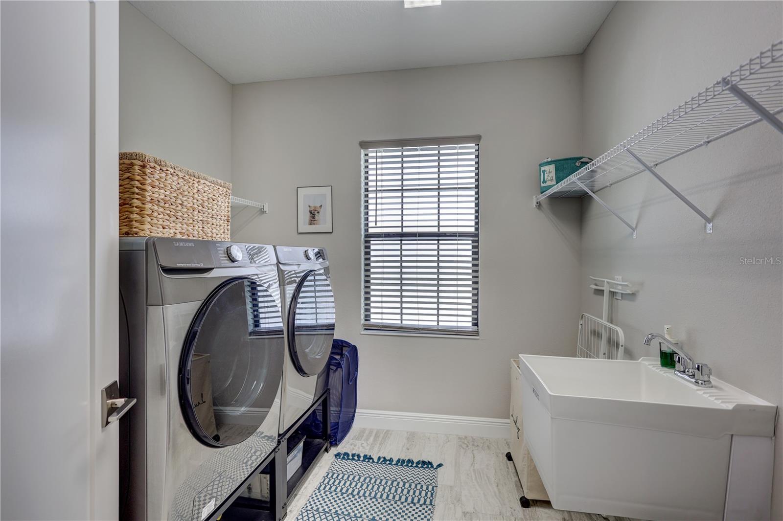 Large, well-appointed laundry room with utility sink - designed to make daily routines effortless and efficient.