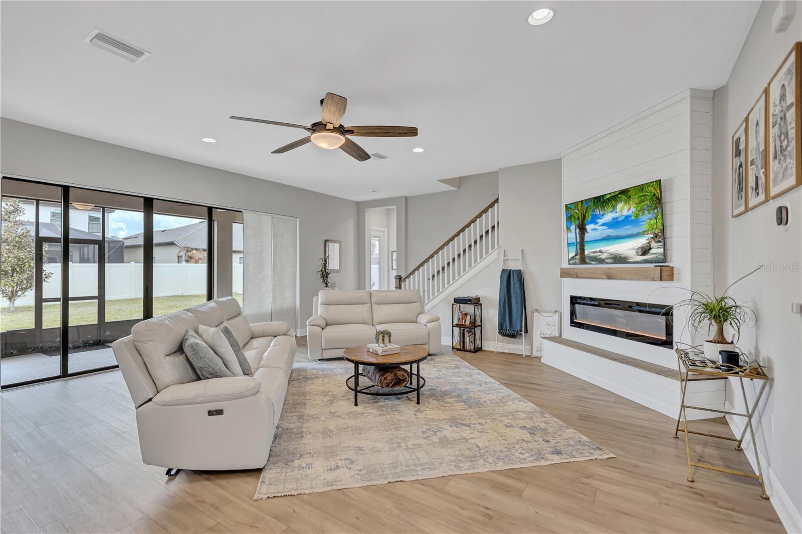 Custom wall feature with electric fireplace creates a sophisticated yet cozy focal point for gathering and entertaining.