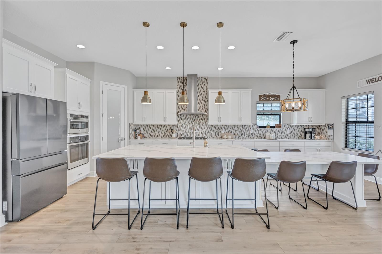 Gourmet kitchen featuring stainless steel appliances, gas cooktop, ample prep space & abundant cabinetry.