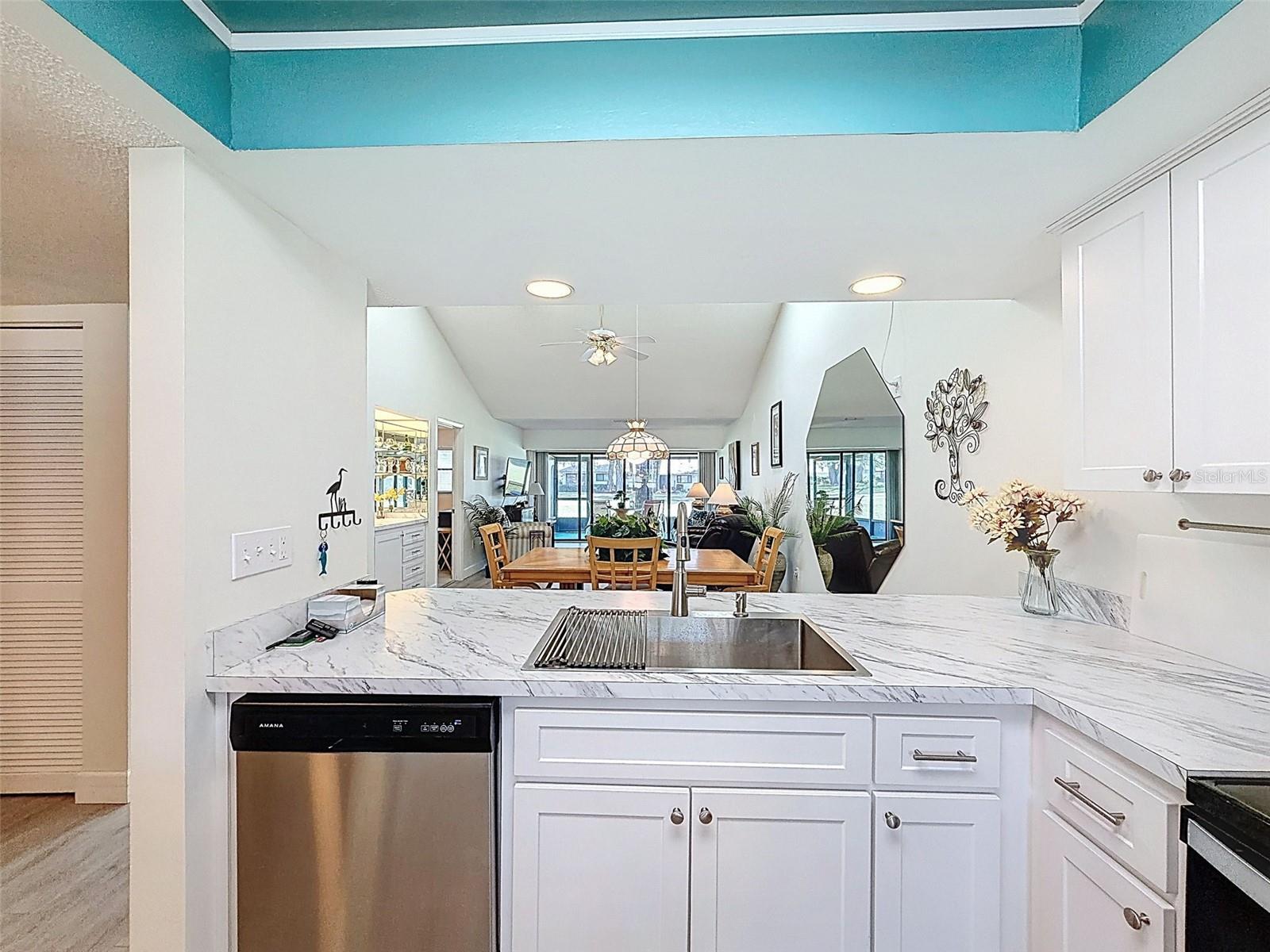 kitchen overlooks into dining room with stools