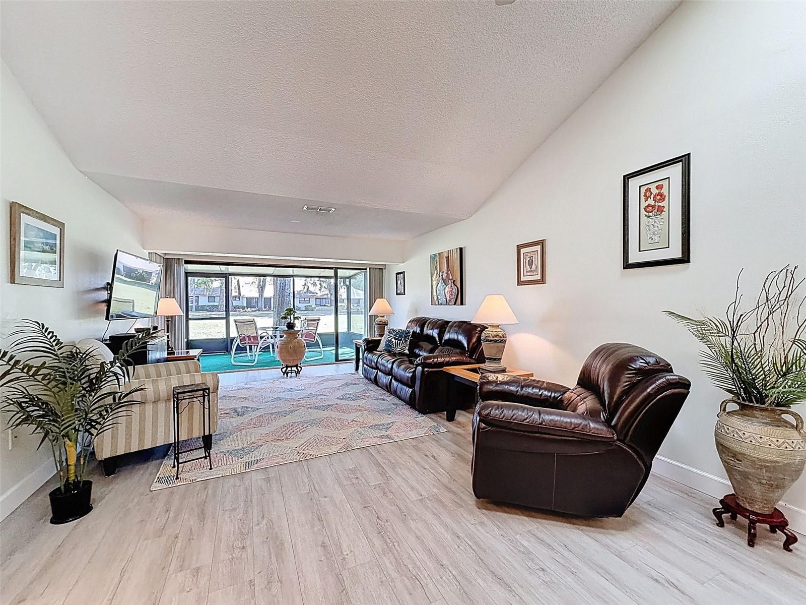 living room to wall of windows to lanai