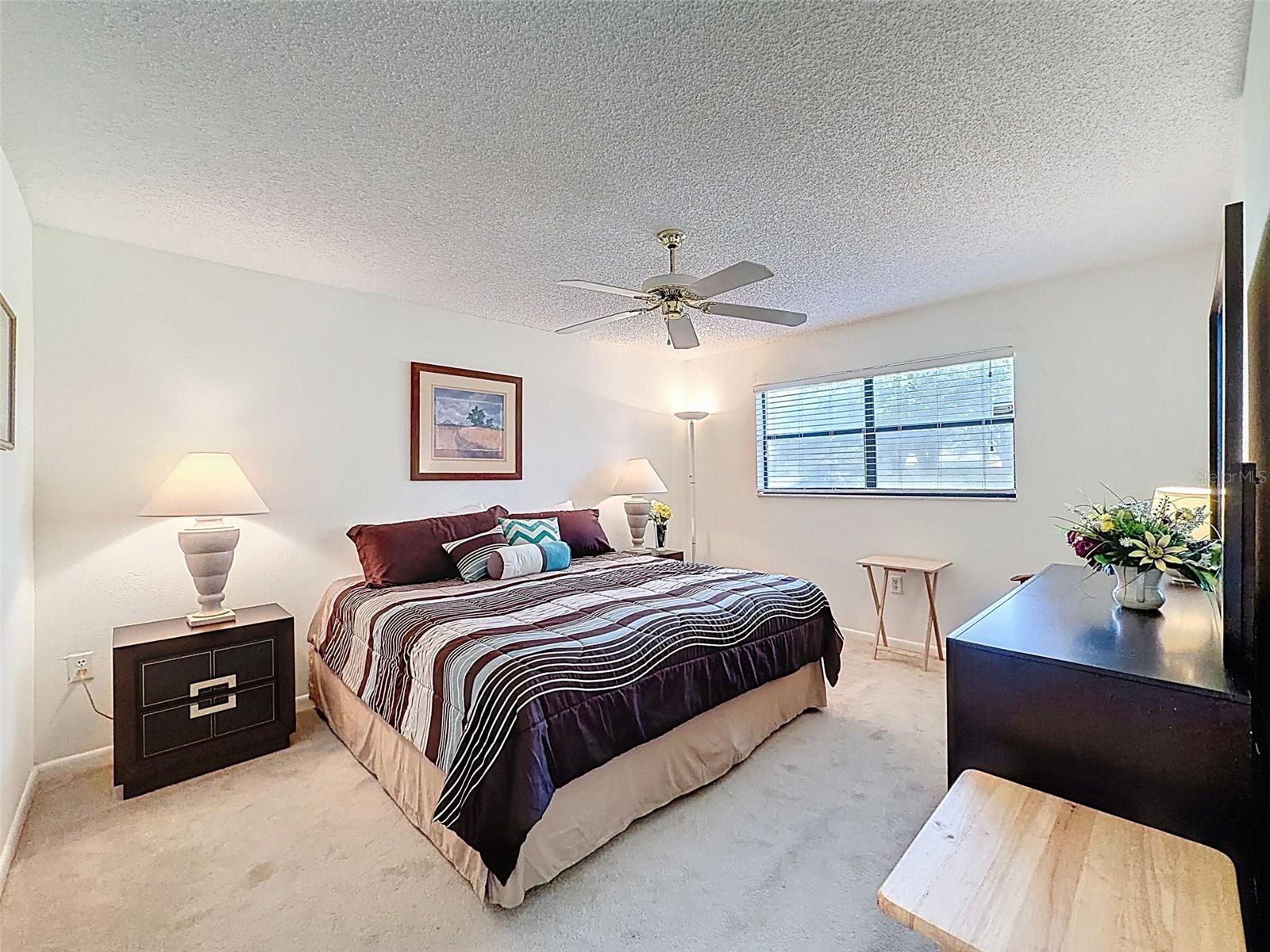 Primary bedroom suite with ensuite bath and walk in closet