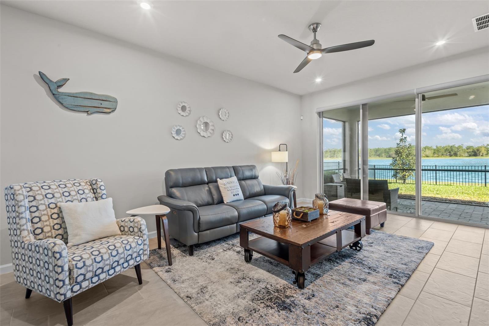 Open living room with large sliding glass doors overlooking the water.