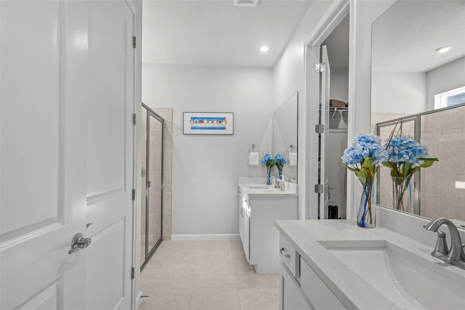 Primary bathroom featuring dual sinks and a well-designed layout.