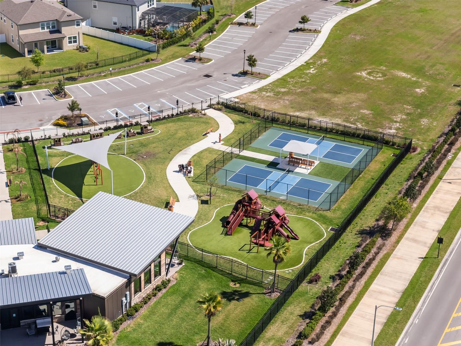 Aerial view of other side of community center - plaground and sports courts
