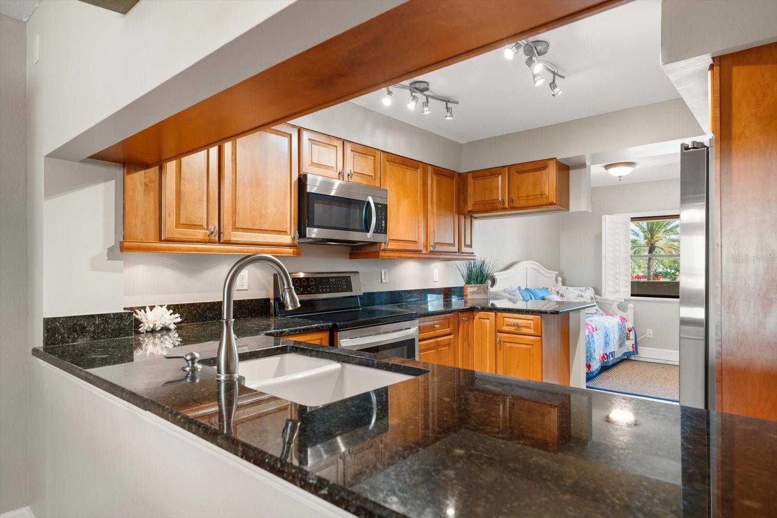 Through the kitchen to the flex space, currently being used as a sitting/additional sleeping space