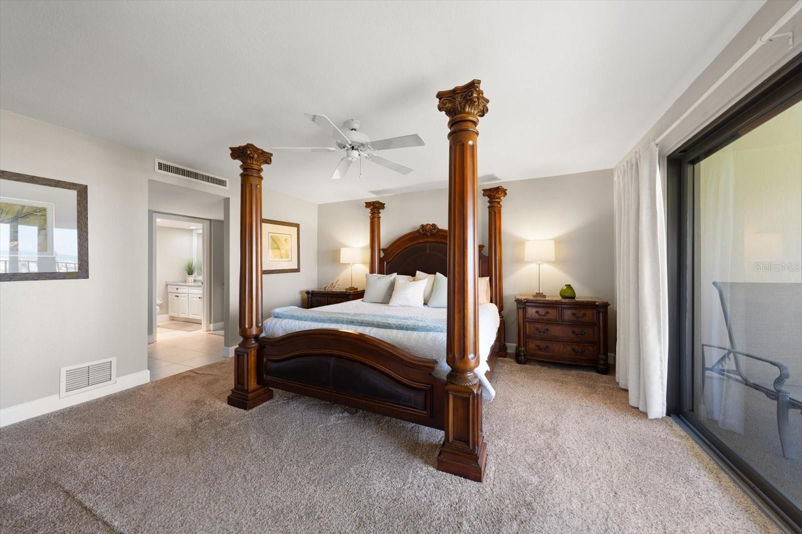 From the living room, looking into the primary suite with opening to walk in closet and master bath