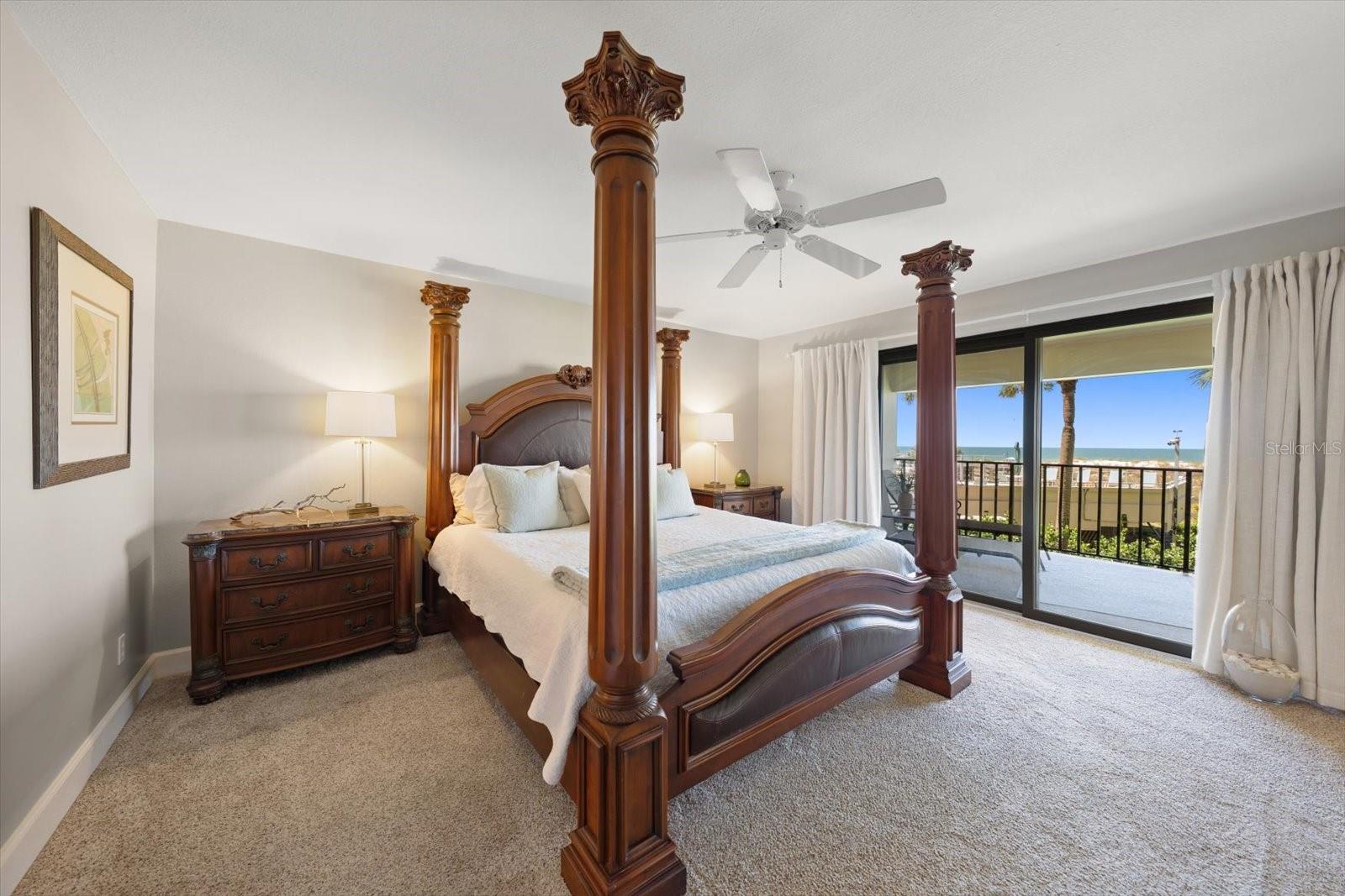View of the Gulf and beach through the sliders in the master bedroom