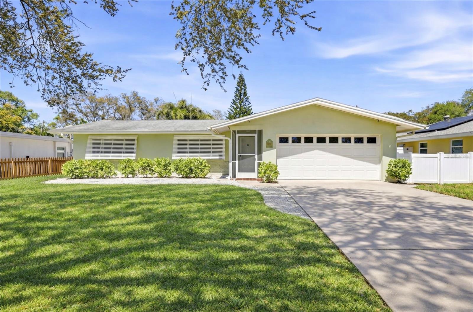 Charming curb appeal with a spacious driveway and mature landscaping