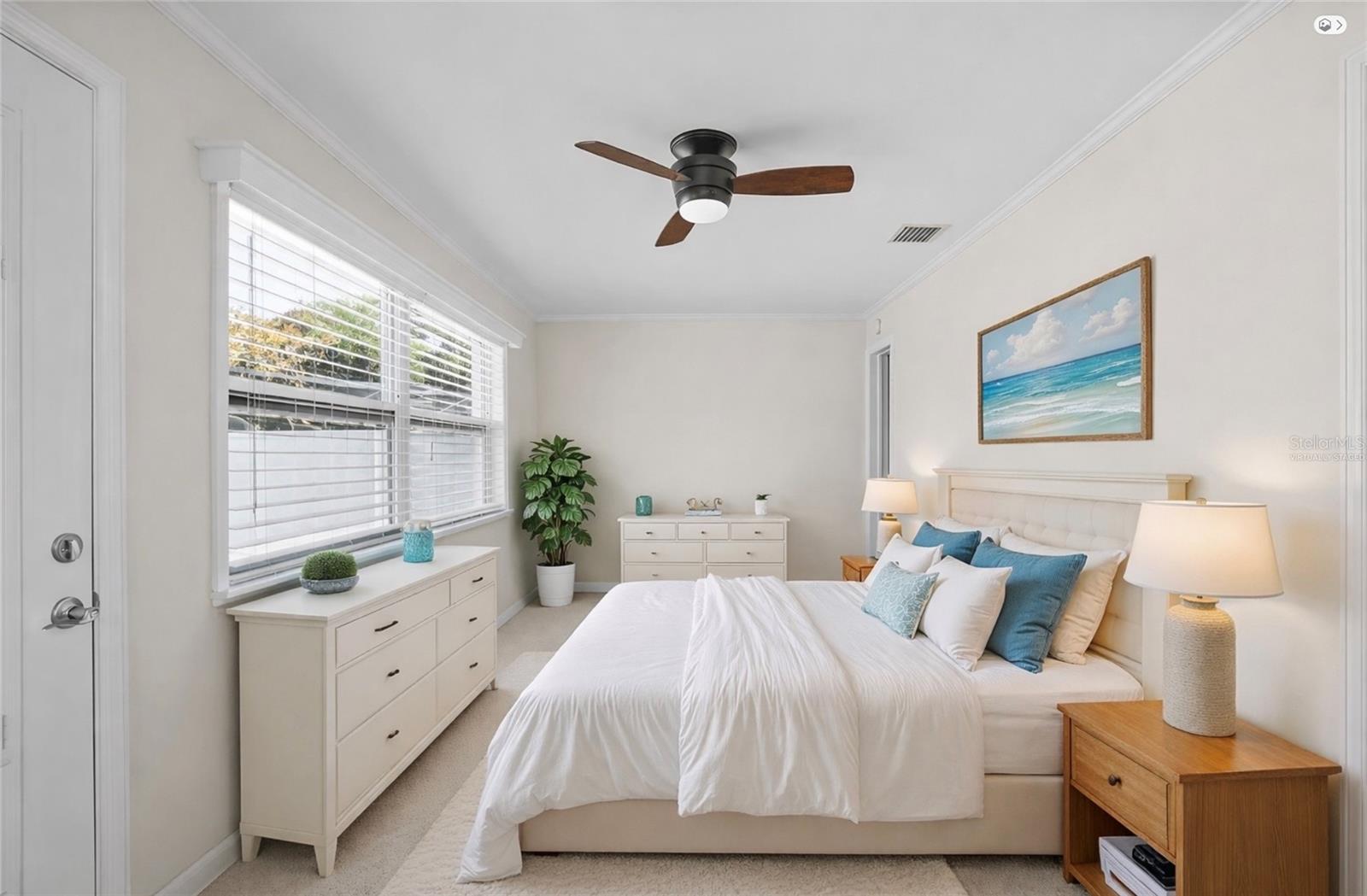 Spacious primary bedroom with abundant natural light