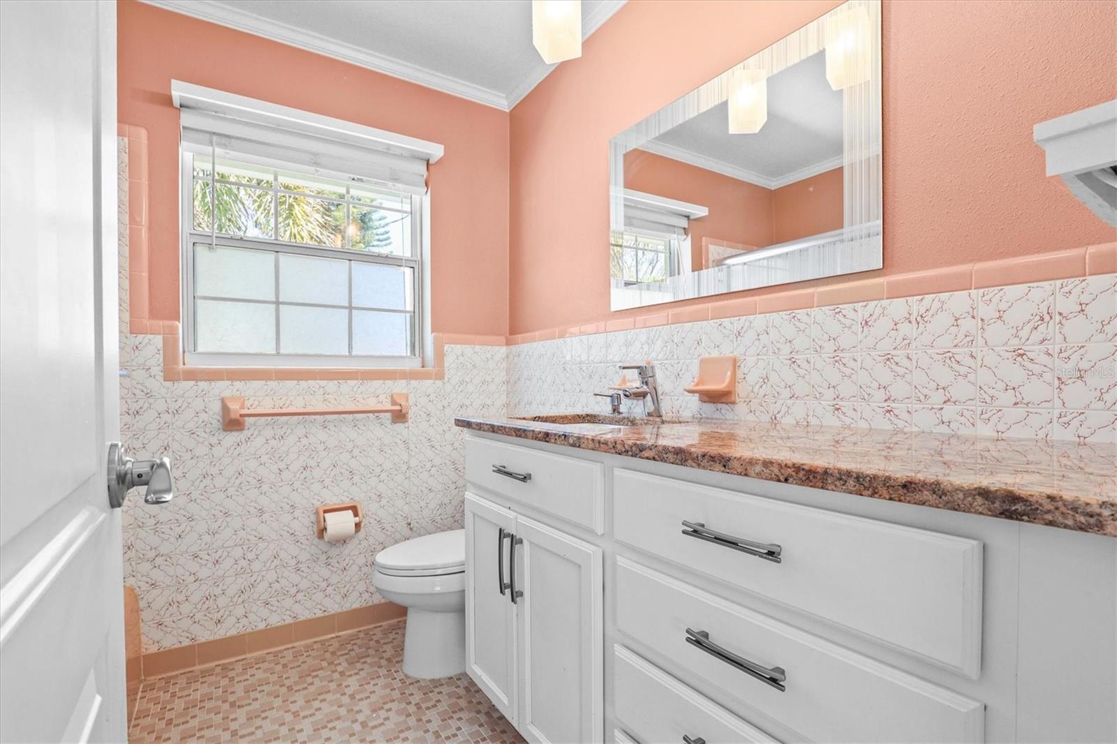 Second bathroom with granite countertop and white shaker cabinetry