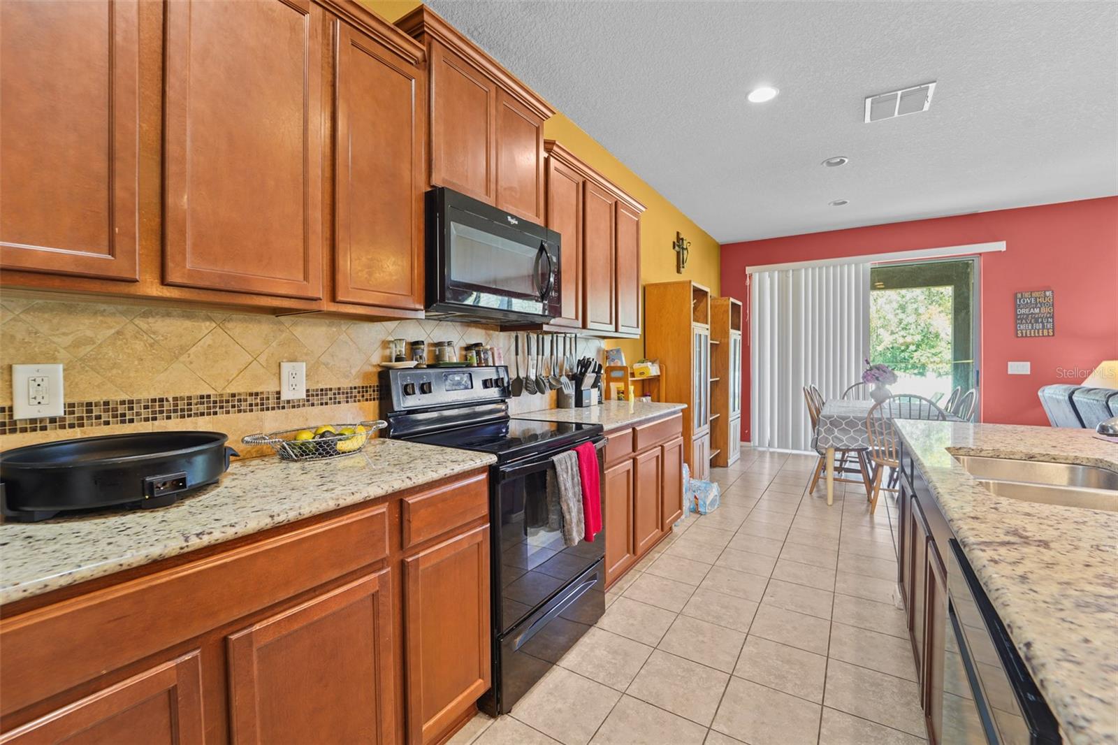 Kitchen view to dining area & slider to Lanai