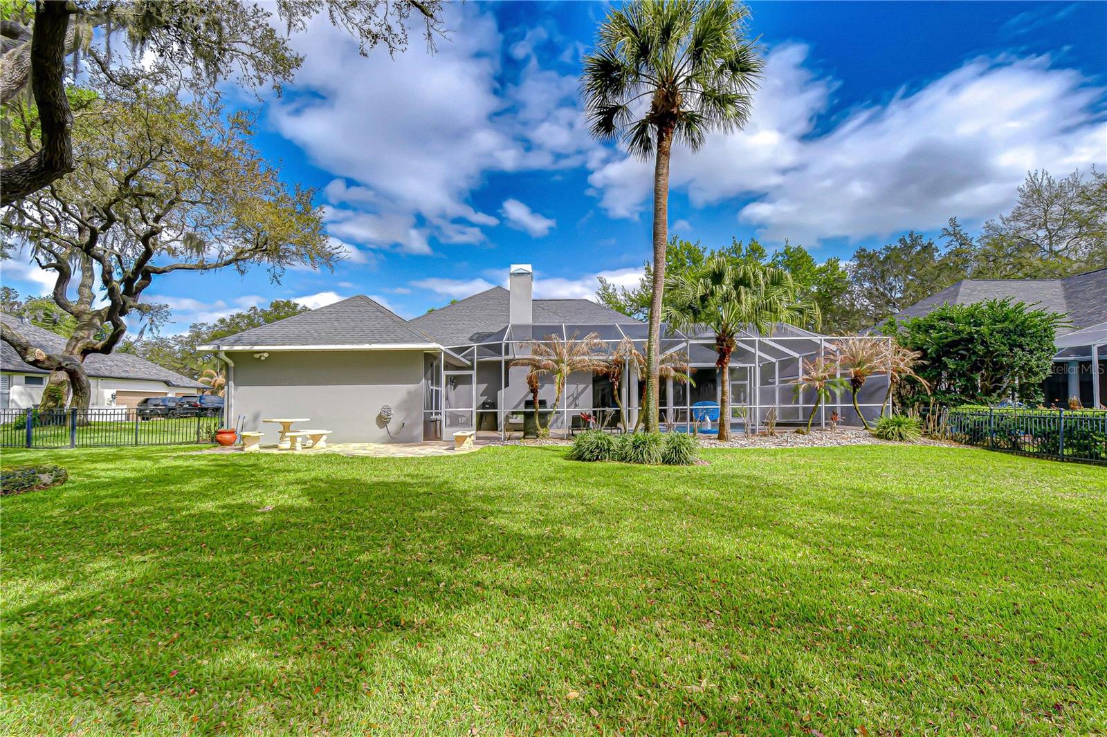 Fully fenced backyard with lush St. Augustine grass.