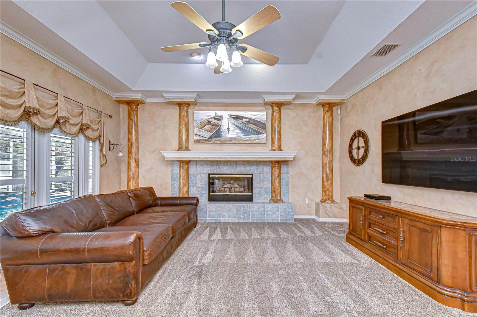 Gas fireplace with decorative columns creating a warm focal point.