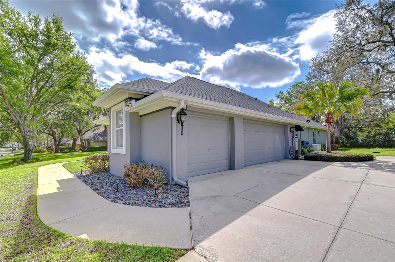 Side-entry 3-car garage with spacious driveway.