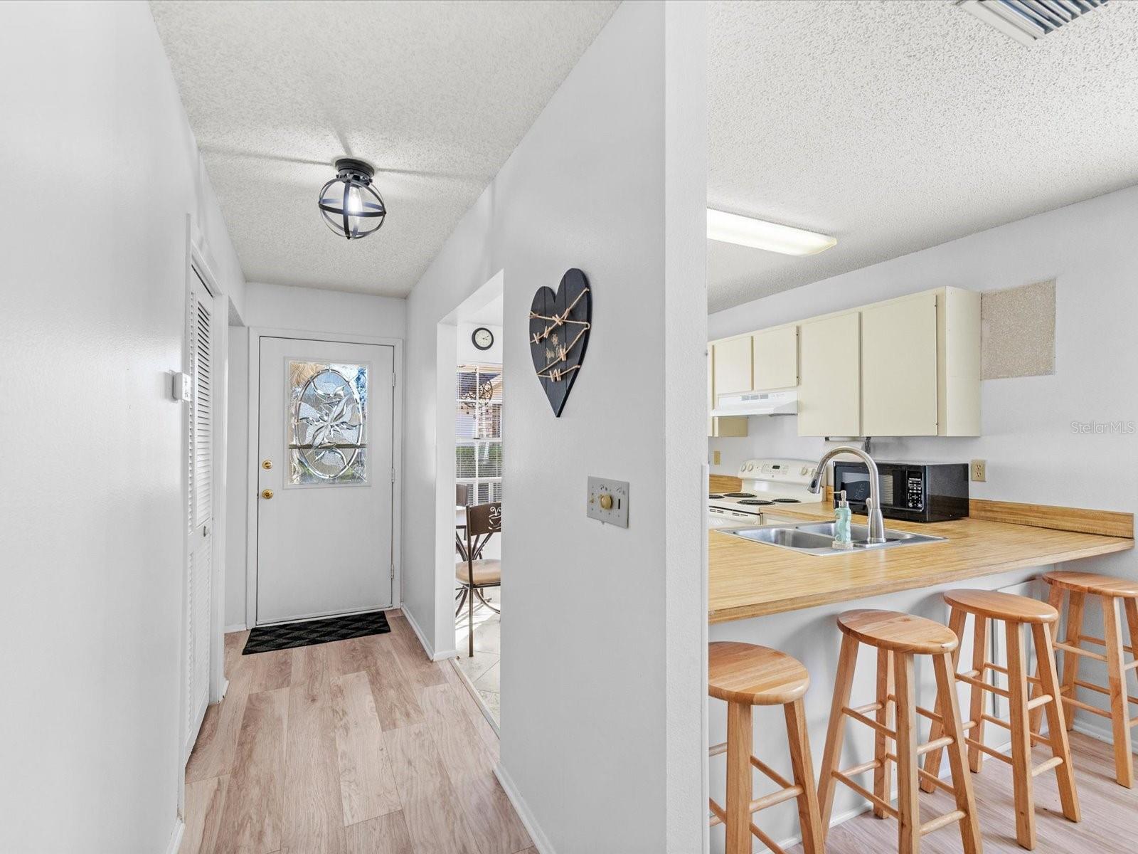 Hall leading to half bathroom and laundry area