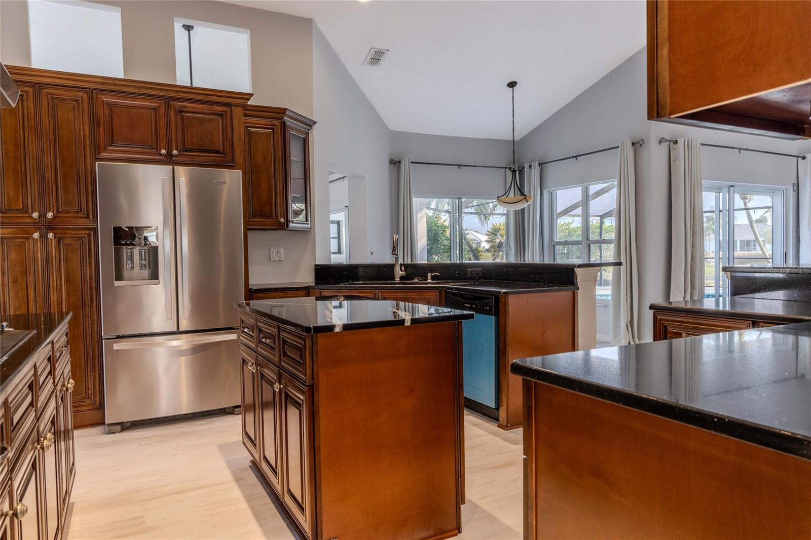 Spacious, Open Kitchen with High Ceilings, Island and Stainless-Steel Appliances