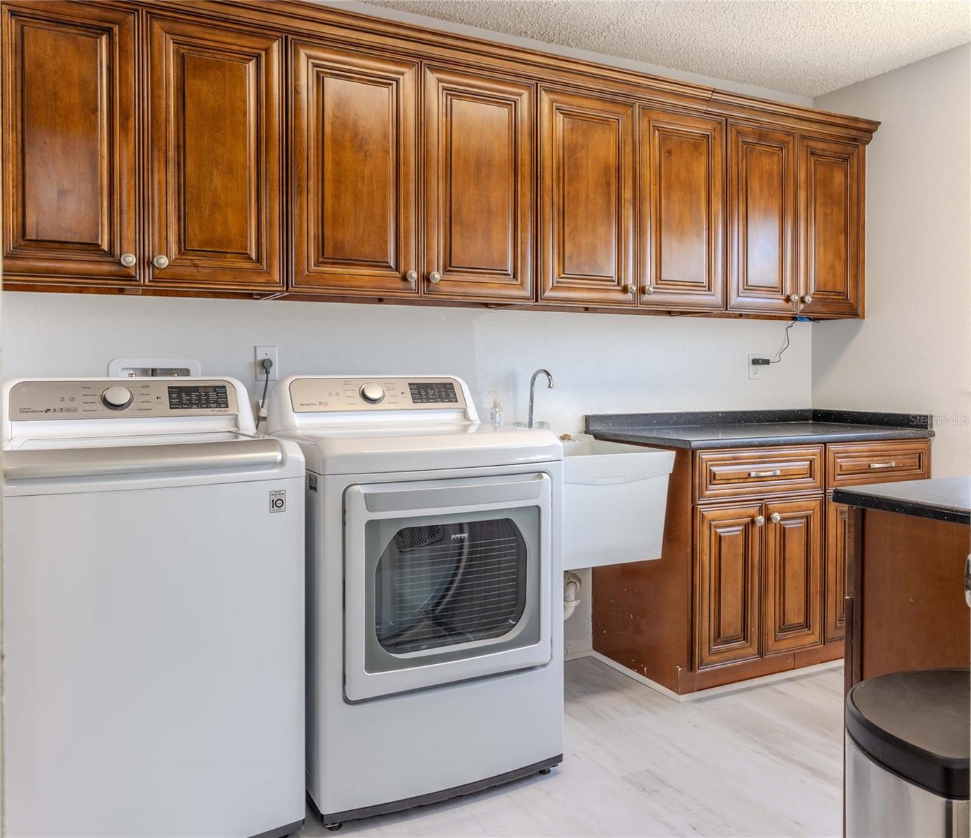 Continuation of Kitchen Wood Cabinets for Storage, Washer, Dryer, and Laundry Tub