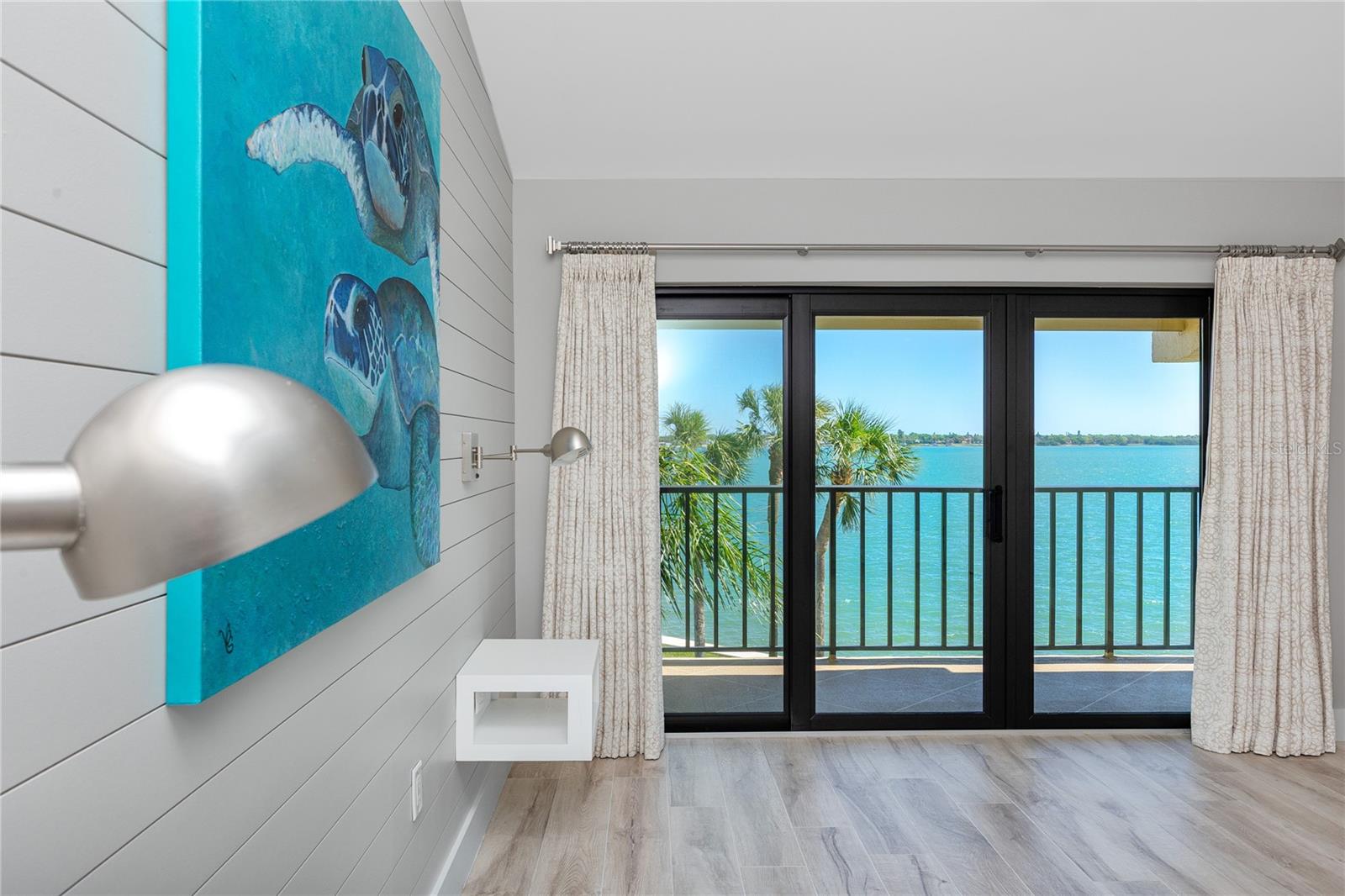 Primary bedroom with balcony overlooking Bay