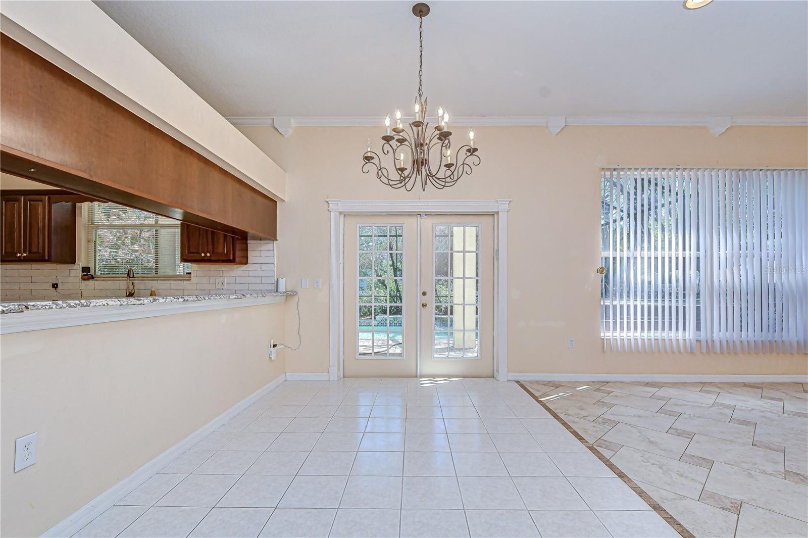Open-concept living space with tile floors, and breakfast bar.