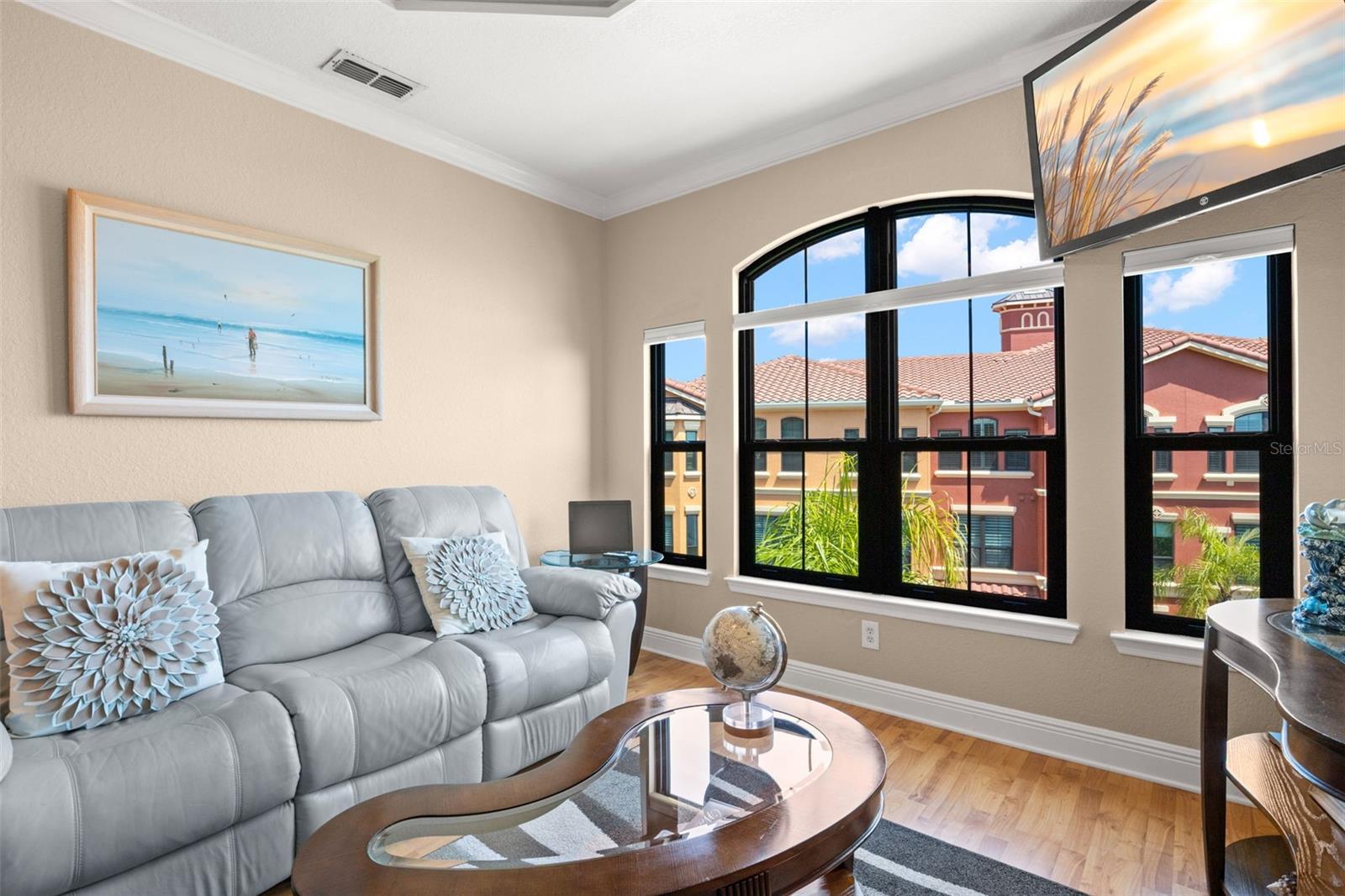 A bright and inviting living space with a neutral palette, wood-look flooring, and architectural detail throughout.