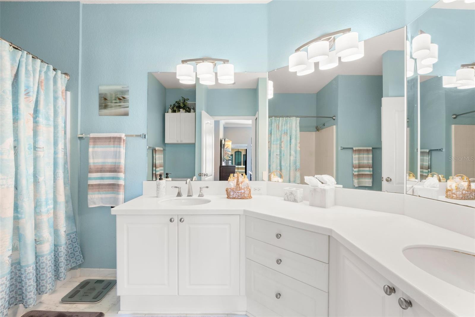 The primary bathroom features a spacious double vanity with ample counter space and storage.