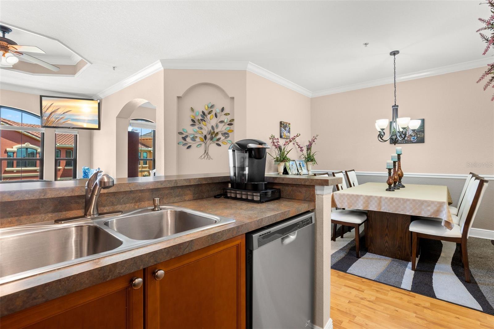 Positioned between the living and dining areas, the kitchen serves as a central hub for gathering and connection.