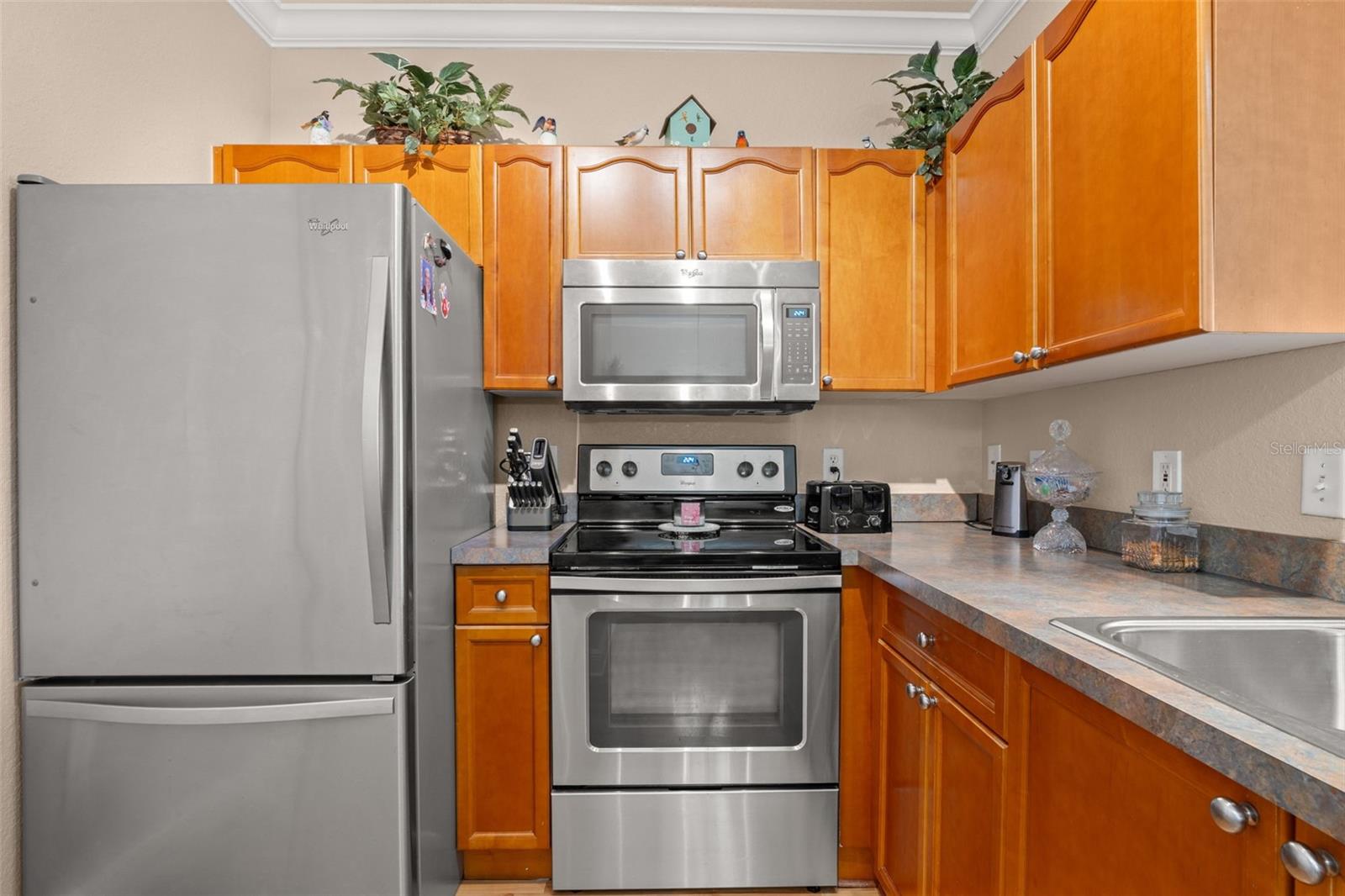 The kitchen features stainless steel appliances, generous cabinetry, and plenty of workspace for everyday use.