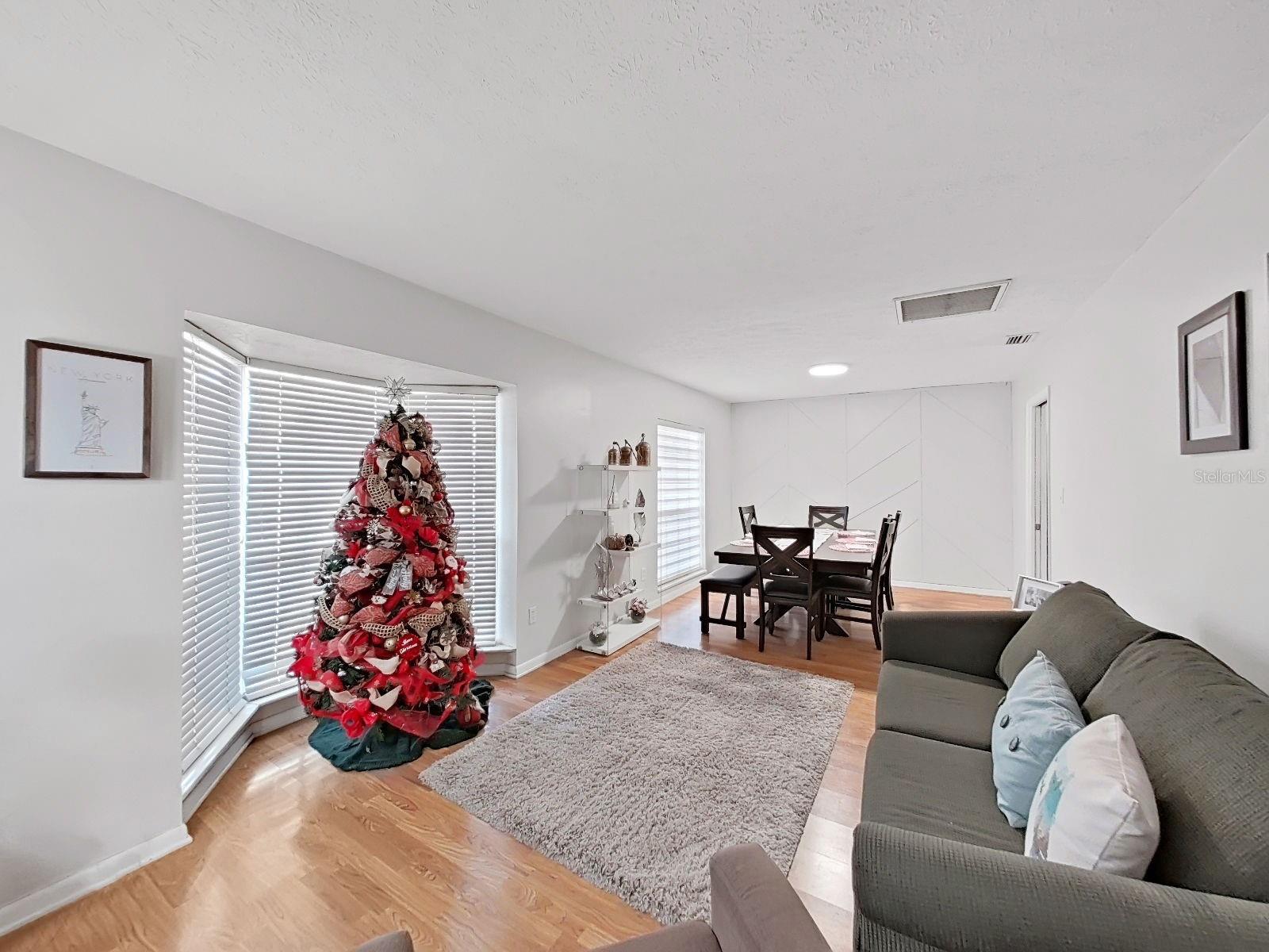 living room w bay window and dining room