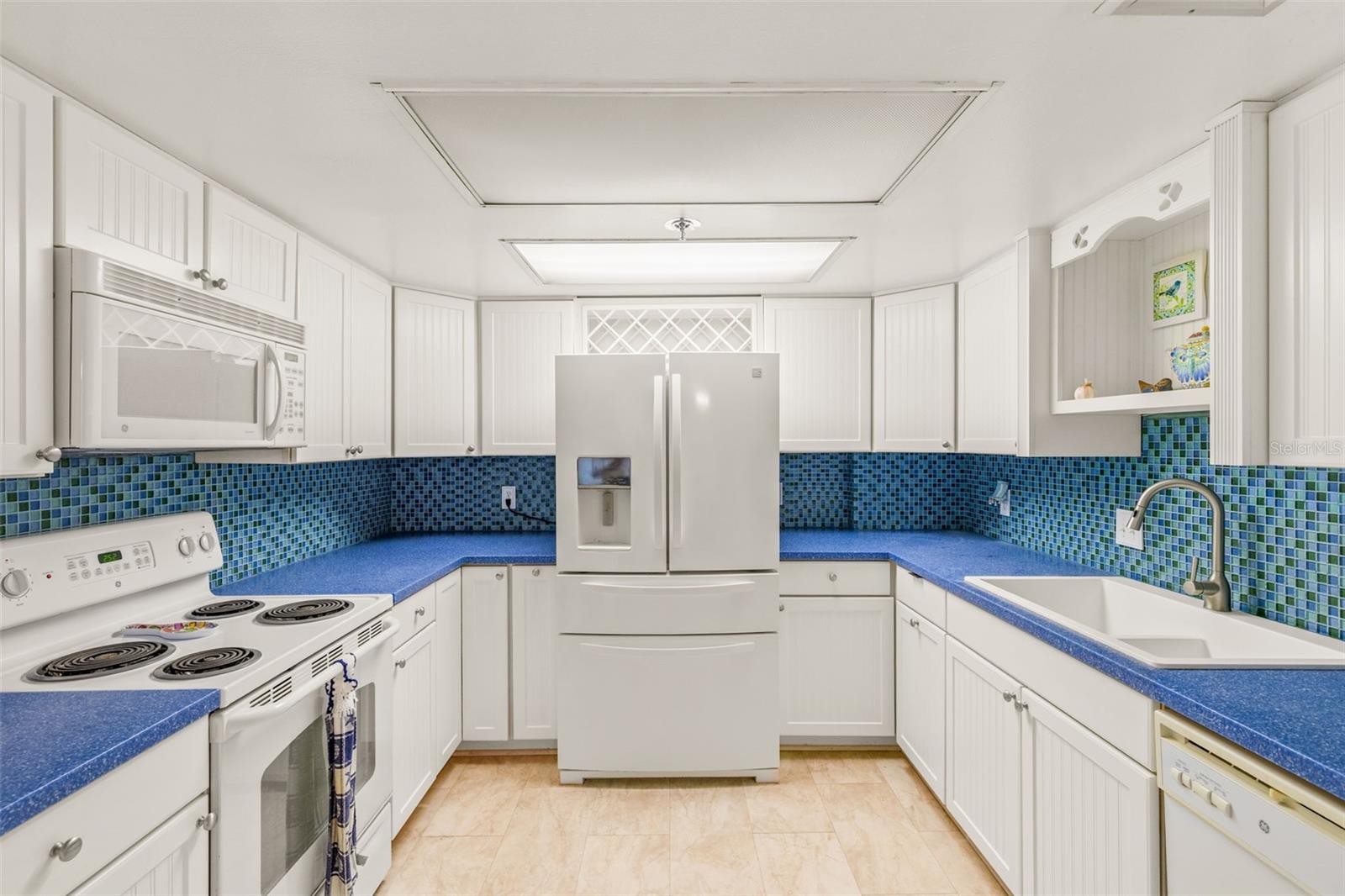 MUCH more functional than original kitchens at key Capri - LOTS of counter space and cabinets... Washer-Dryer here as well