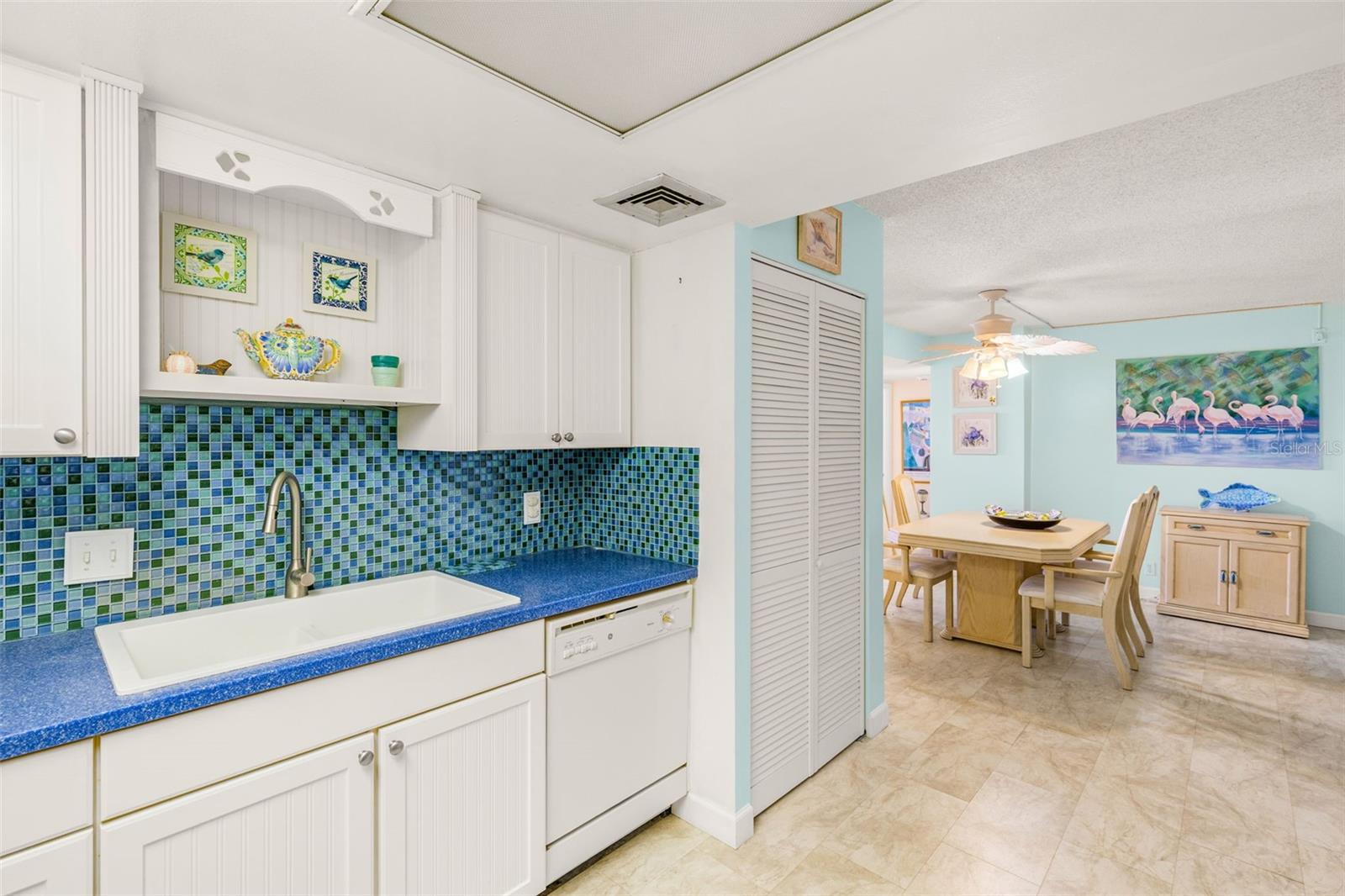 Flows from Kitchen to Dining Area - that louvered closet holds the Washer / Dryer
